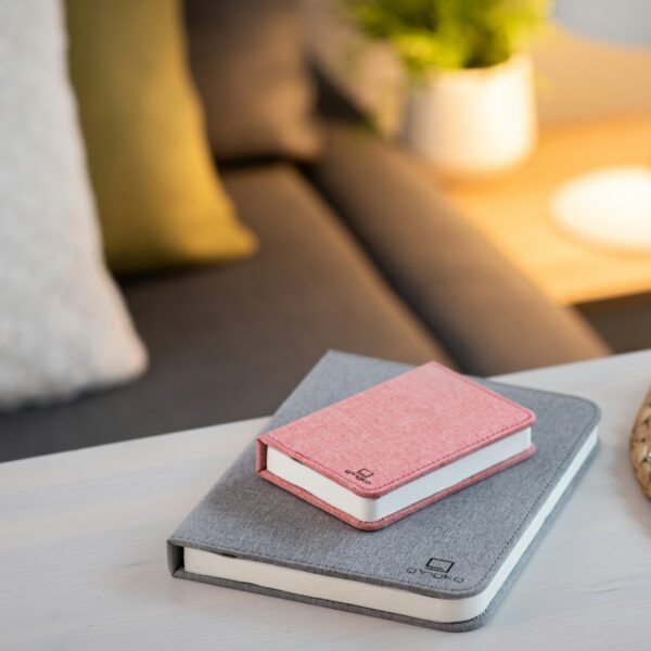 Gingko smart mini book light in pink placed on larger book light