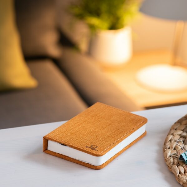 Gingko smart mini book light in orange on table