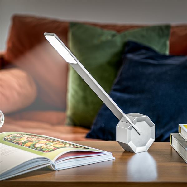 Gingko Octagon one desk lamp in Silver Aluminium lightng a book