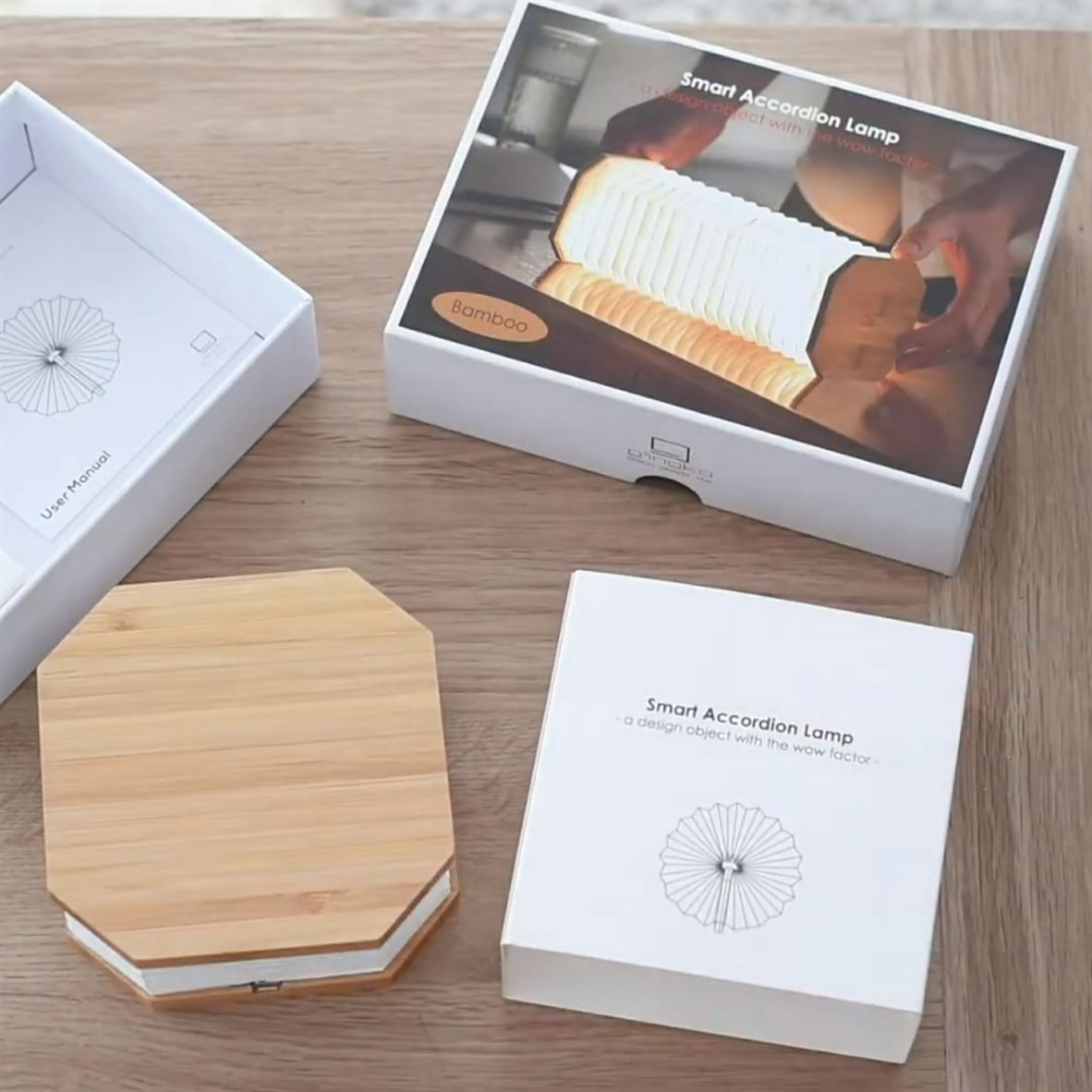 Gingko Smart Accordion Lamp packaging in maple