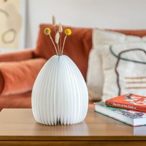 Smart Vase Light lit in lounge with white flowers against orange softa