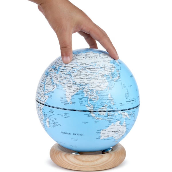 Gingko Large Light Sky Blue Atlas Globe showing a hand for proportion